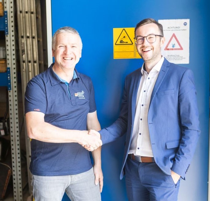 Thomas Knapp und Michael Kainrath schließen das Projekt mit Handschlag ab